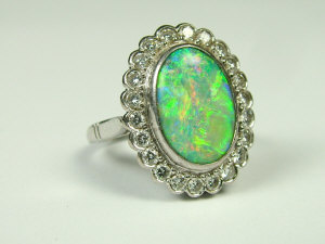 Appraisal: A ct white gold opal and diamond set dress ring