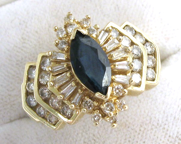 Appraisal: SAPPHIRE DIAMOND AND FOURTEEN KARAT GOLD RING centering a marquise-cut