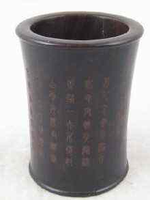 Appraisal: A Chinese turned hardwood brushpot with incised decoration pictograms and