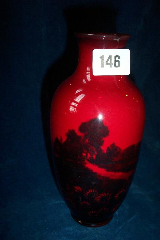 Appraisal: A Royal Doulton flambe vase with continuous landscape panelling incorporating