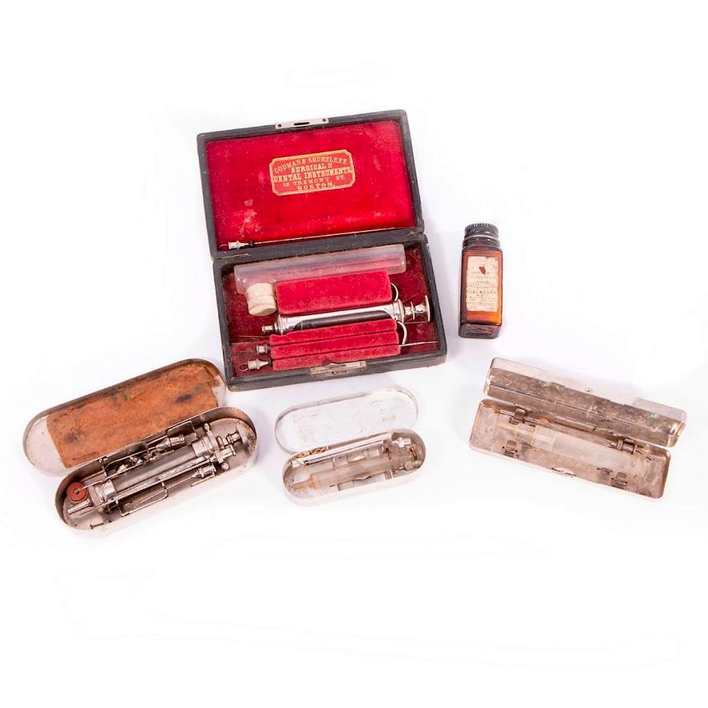 Appraisal: Four antique syringe sets and a bottle of pills Four