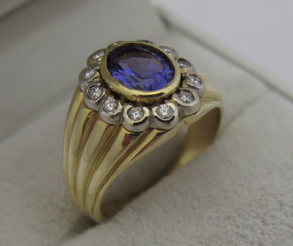 Appraisal: AMETHYST DIAMOND AND K GOLD RING centering an oval-cut purple