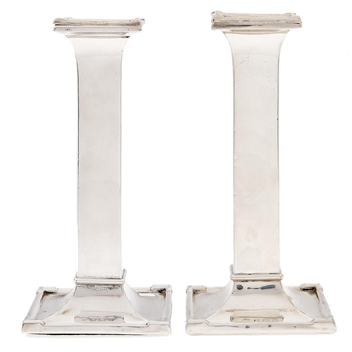 Appraisal: A pair of George V silver candlesticks of plain square