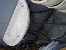 Appraisal: A small wrought iron plant stand with white stone basin