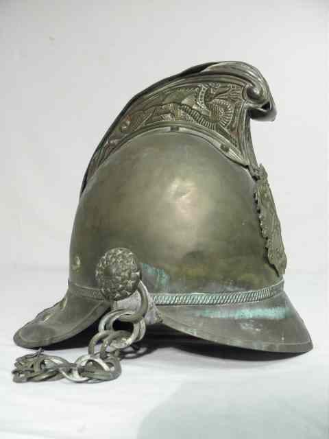 Appraisal: Early brass fire brigade helmet Embossed top leather lined interior