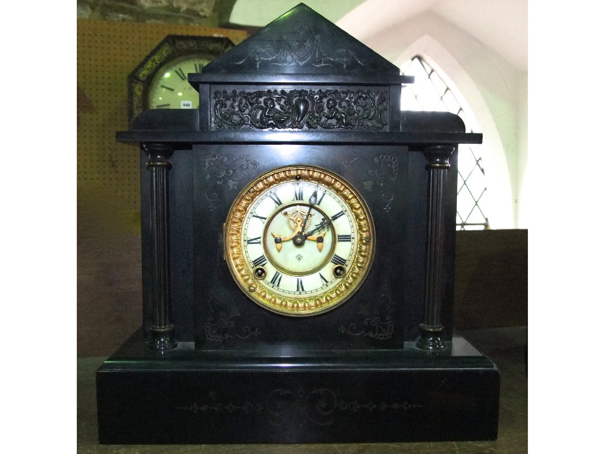 Appraisal: An Ansonia black slate mantle clock of classical outline with