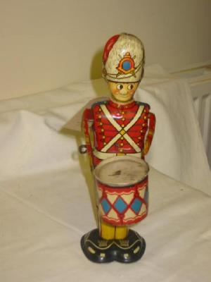 Appraisal: An English drummer boy tin plate clockwork action operates drumming