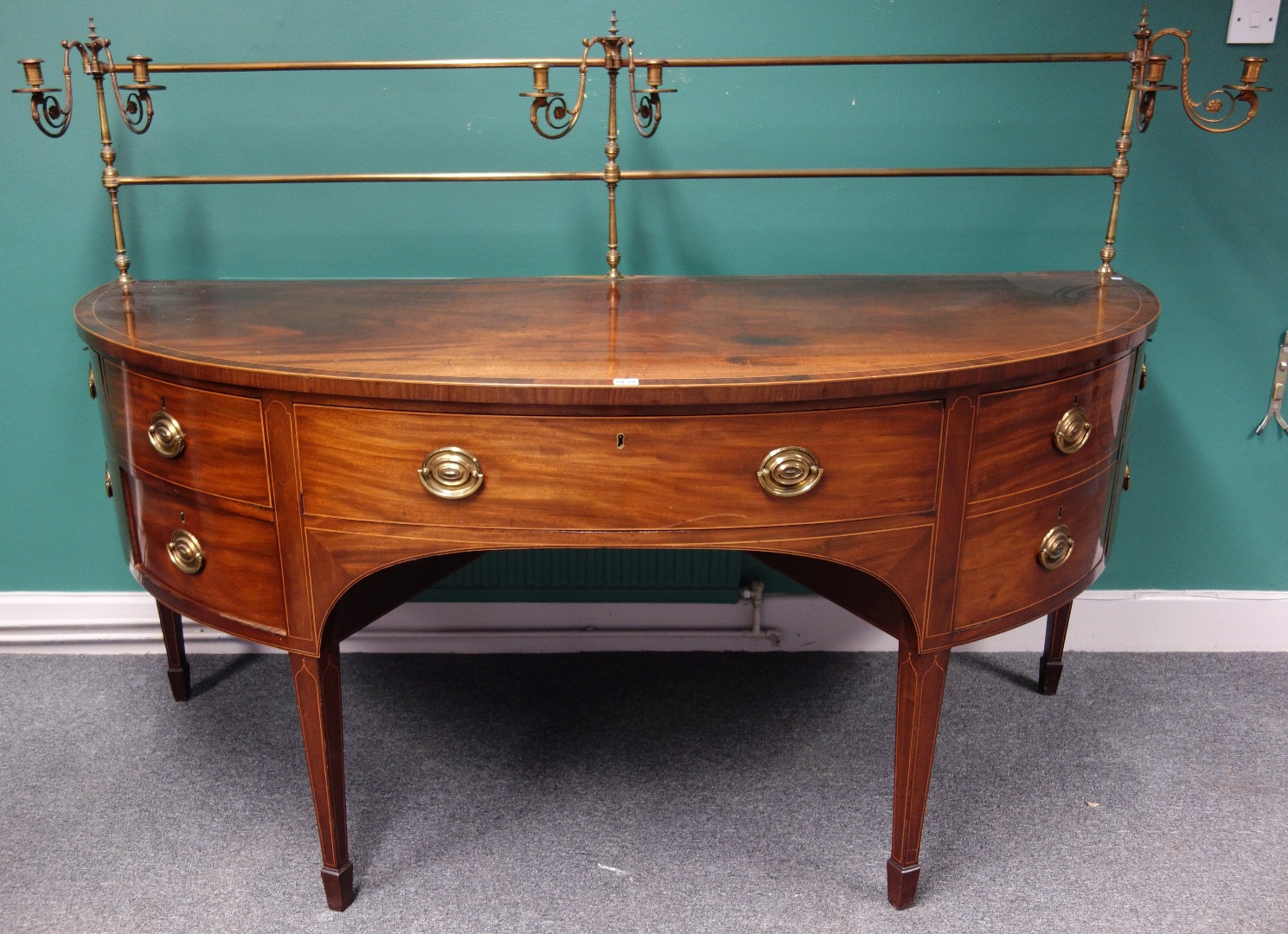 Appraisal: A George III Scottish inlaid mahogany bowfront sideboard with candle