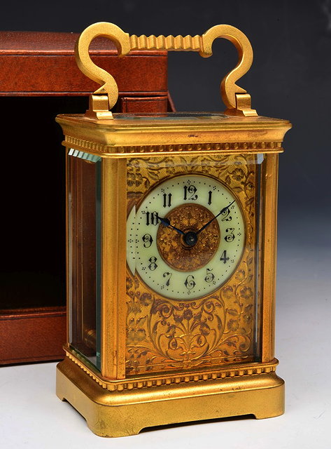 Appraisal: A FRENCH GILT BRASS CARRIAGE CLOCK with white enamel dial