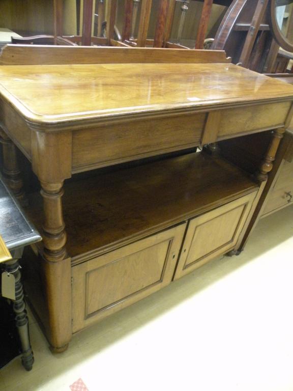 Appraisal: A mid Victorian walnut buffet with two frieze drawers on