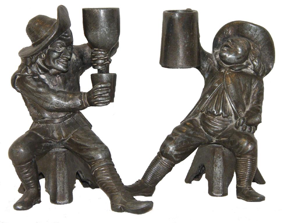 Appraisal: Pair of novelty pewter figural candlesticks modelled as seated Cavaliers