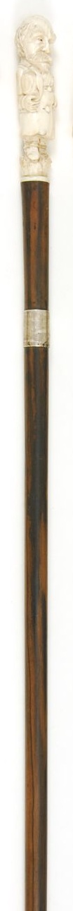 Appraisal: IVORY-HANDLED AND GOLD-BANDED EBONY CANE Carved handle in the form