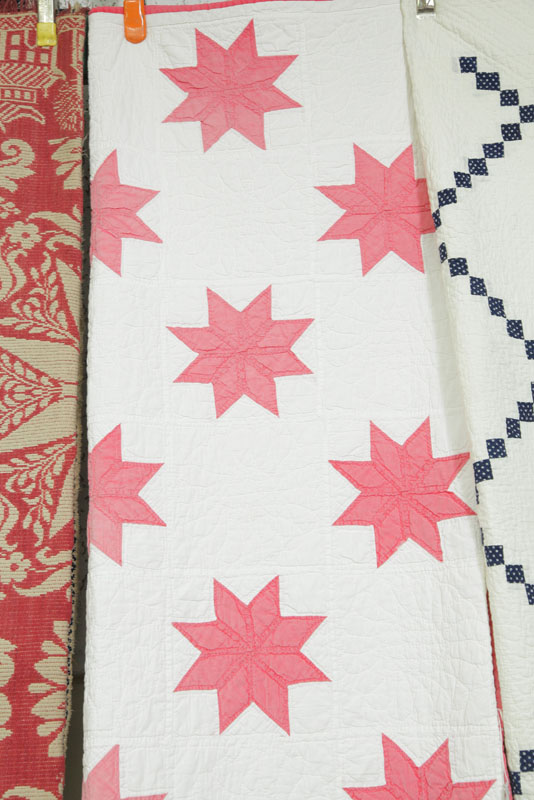 Appraisal: QUILT WITH RED STARS Cotton quilt with a white ground