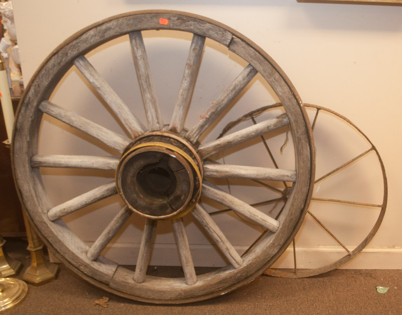 Appraisal: Large wood wagon wheel and a metal wagon wheel Undernumber