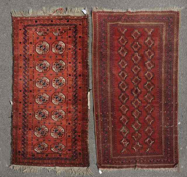 Appraisal: AN AFGHAN WINE GROUND RUG decorated two rows of octagons