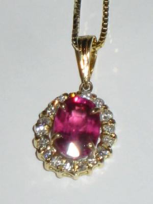 Appraisal: A RUBY AND DIAMOND PENDANT the oval cut ruby claw