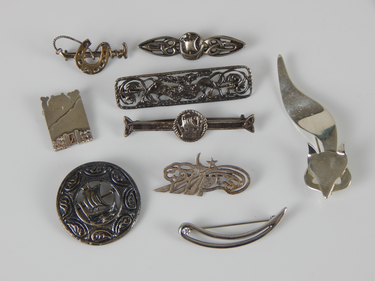 Appraisal: Nine brooches to include Viking boats fox mask horseshoe etc