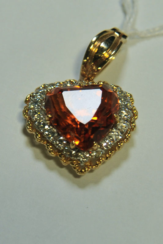 Appraisal: DIAMOND HEART PENDANT Central citrine surrounded by diamonds Mount not