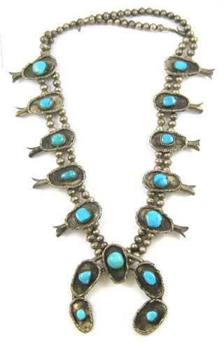 Appraisal: NAVAJO SILVER AND TURQUOISE SQUASH BLOSSOM NECKLACE Fifteen natural turquoise