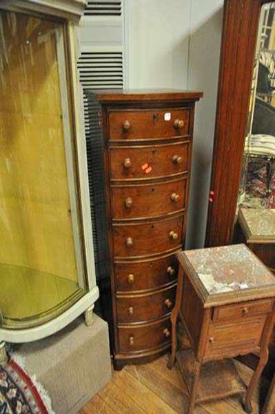 Appraisal: A VICTORIAN STYLE BOW FRONT WELLINGTON CHEST OF SEVEN DRAWERS