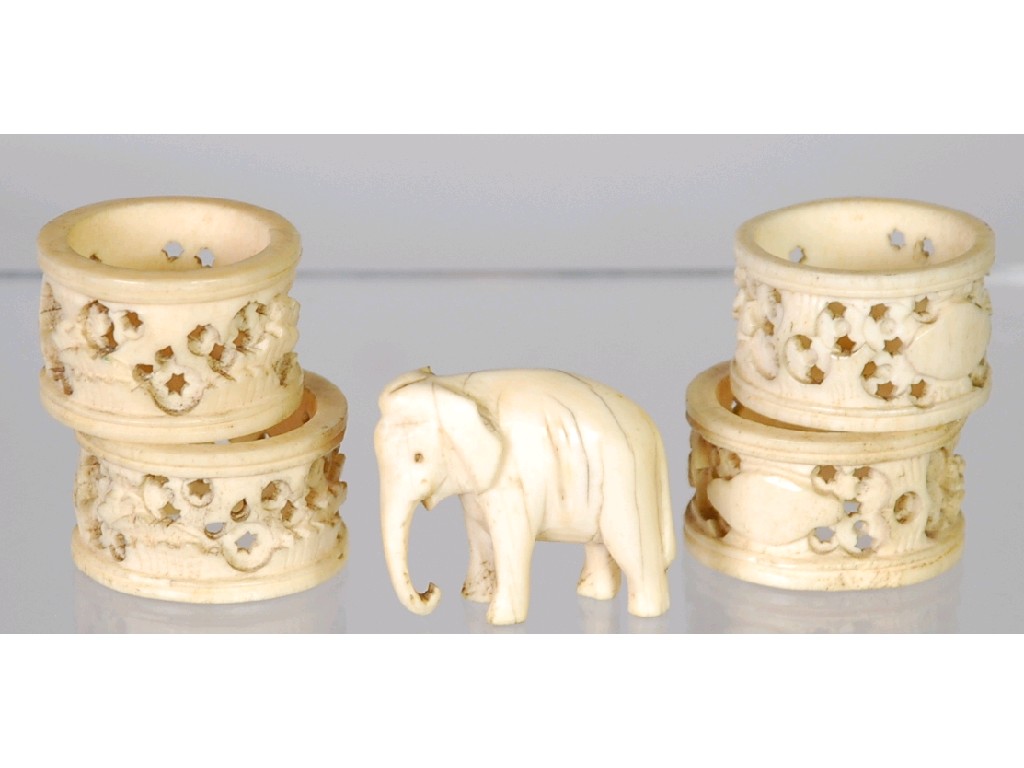 Appraisal: FOUR CARVED AND PIERCED IVORY NAPKIN RINGS AND A SMALL