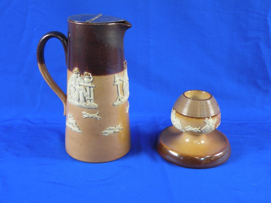 Appraisal: A Royal Doulton stoneware hot water jug decorated in relief