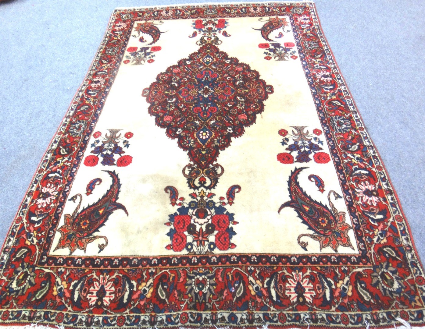 Appraisal: A Sarough rug Persian the plain ivory field with a