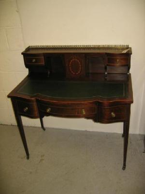 Appraisal: AN EDWARDIAN MAHOGANY DESK of serpentine fronted oblong form with