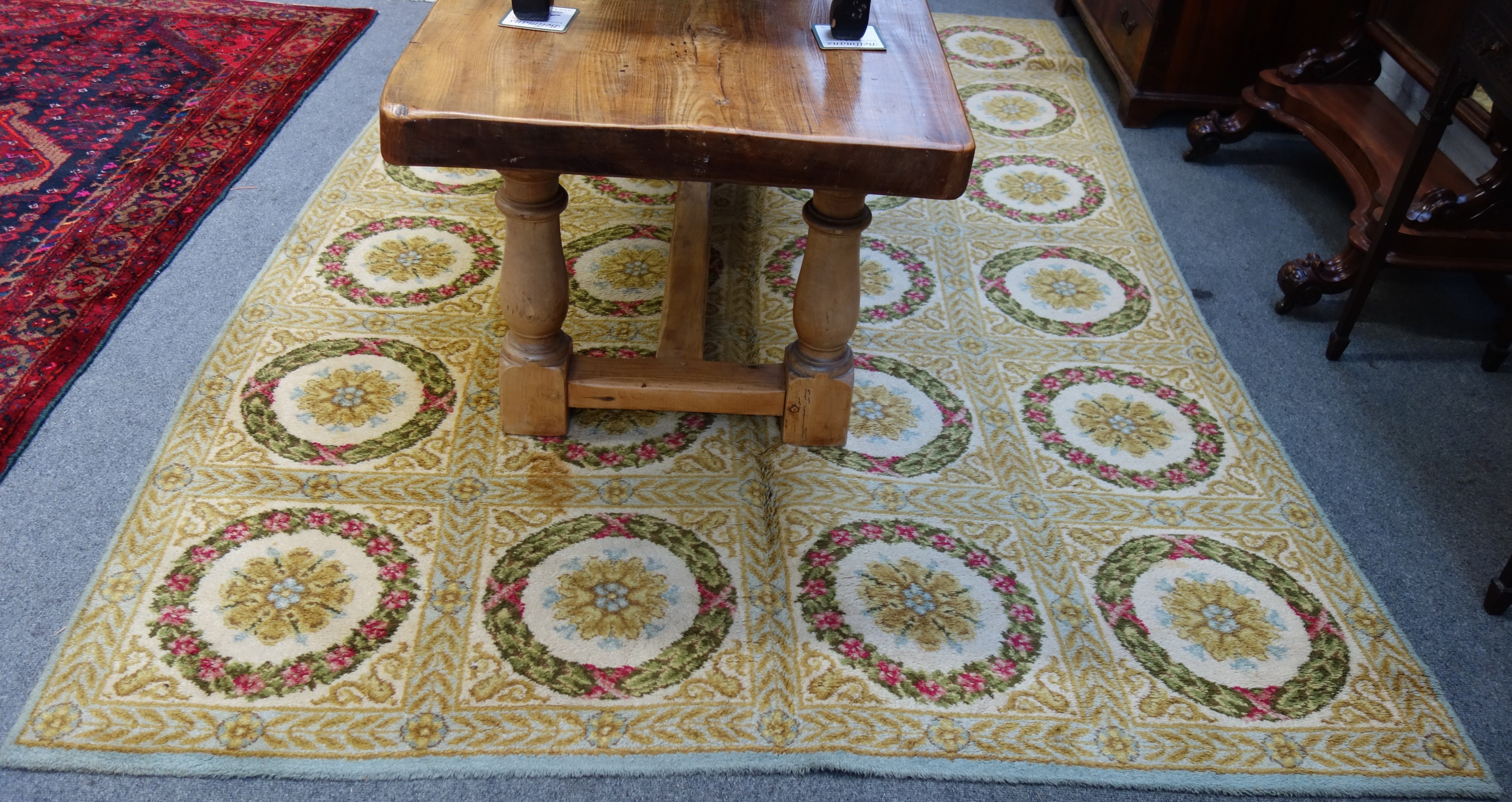 Appraisal: A machine made carpet of Aubussion design with panels of