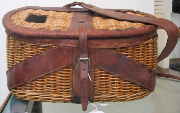 Appraisal: AN AMERICAN MADE WICKER WOVEN FISHING CREEL with leather edges