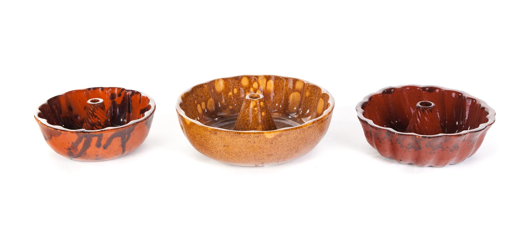 Appraisal: THREE AMERICAN REDWARE FOOD MOLDS Mid th century One with