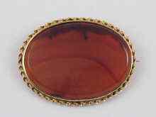 Appraisal: An oval agate brooch set in yellow metal marked ct