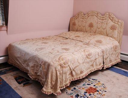 Appraisal: SILK-UPHOLSTERED BEDSTEAD The shaped headboard and box spring covered with