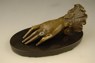 Appraisal: A late th century bronze clip modelled as a ladies