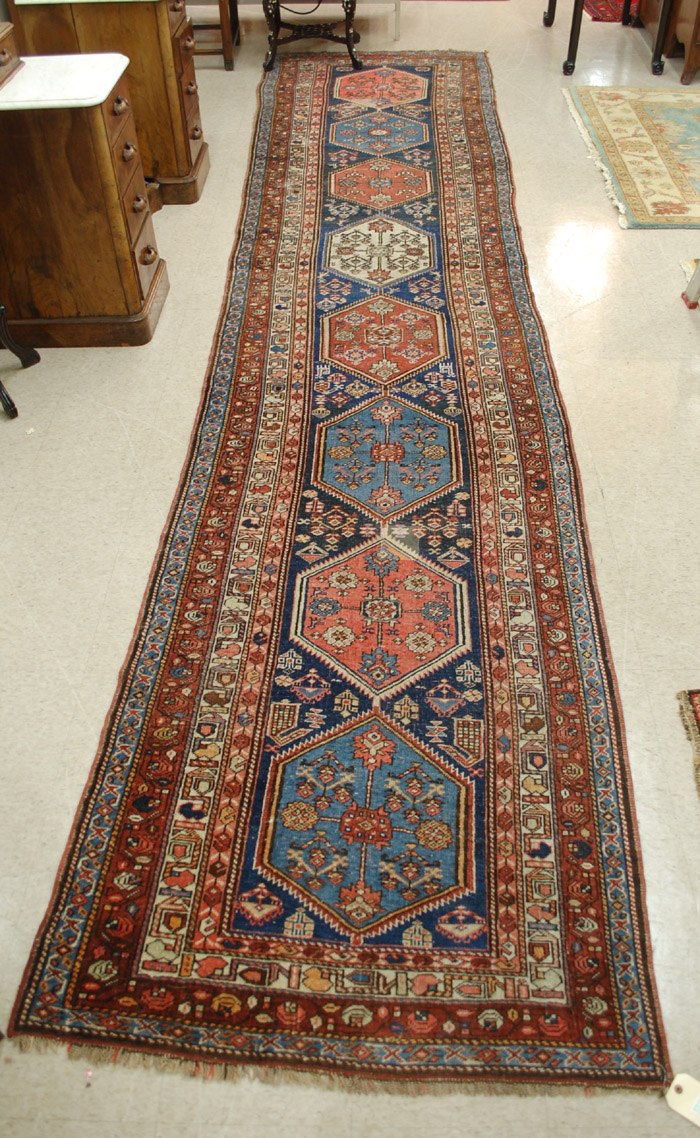 Appraisal: SEMI-ANTIQUE PERSIAN TRIBAL RUNNER featuring a row of eight hexagonal