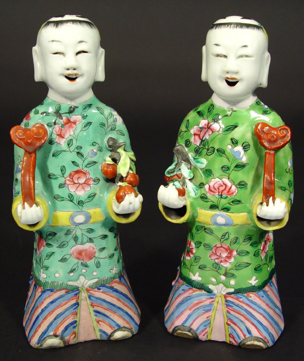 Appraisal: Two Japanese porcelain figures clutching objects each with hand enamelled