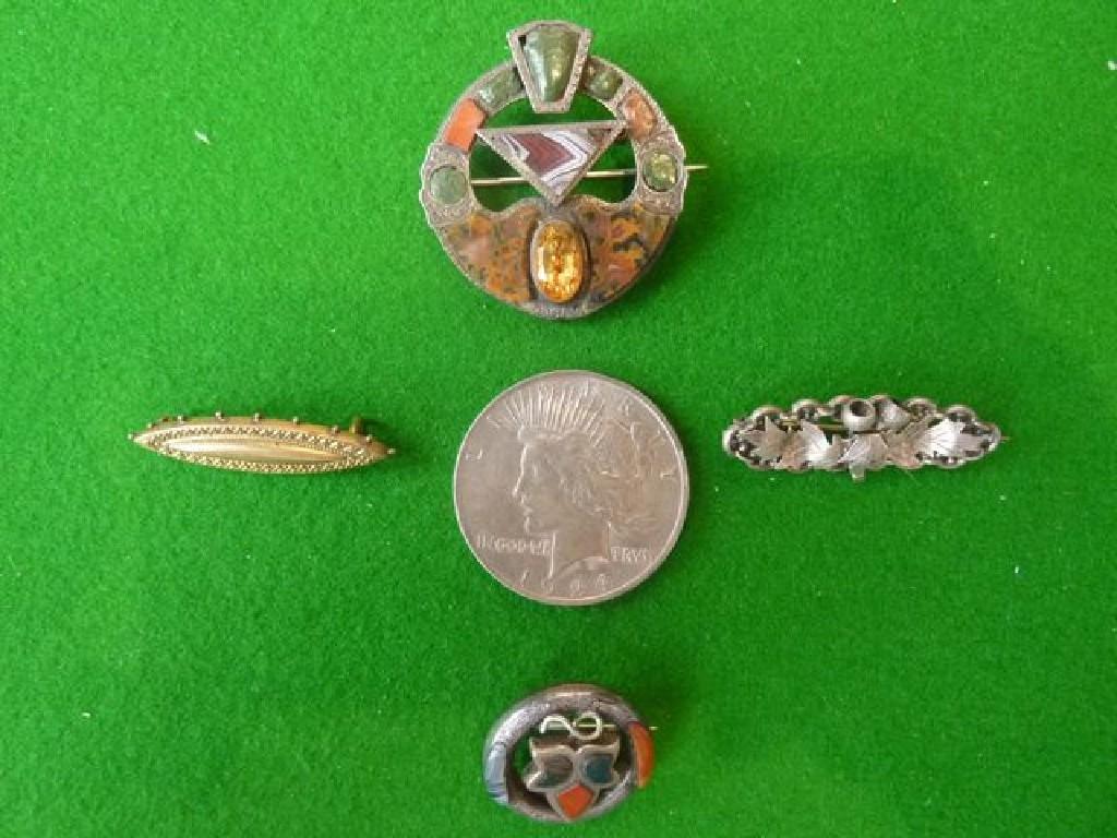 Appraisal: Two Scottish brooches silver bar brooch navette brooches US coin