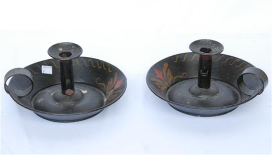 Appraisal: PAIR ANTIQUE TOLE CHAMBERSTICKS Ebonized and stenciled with push up