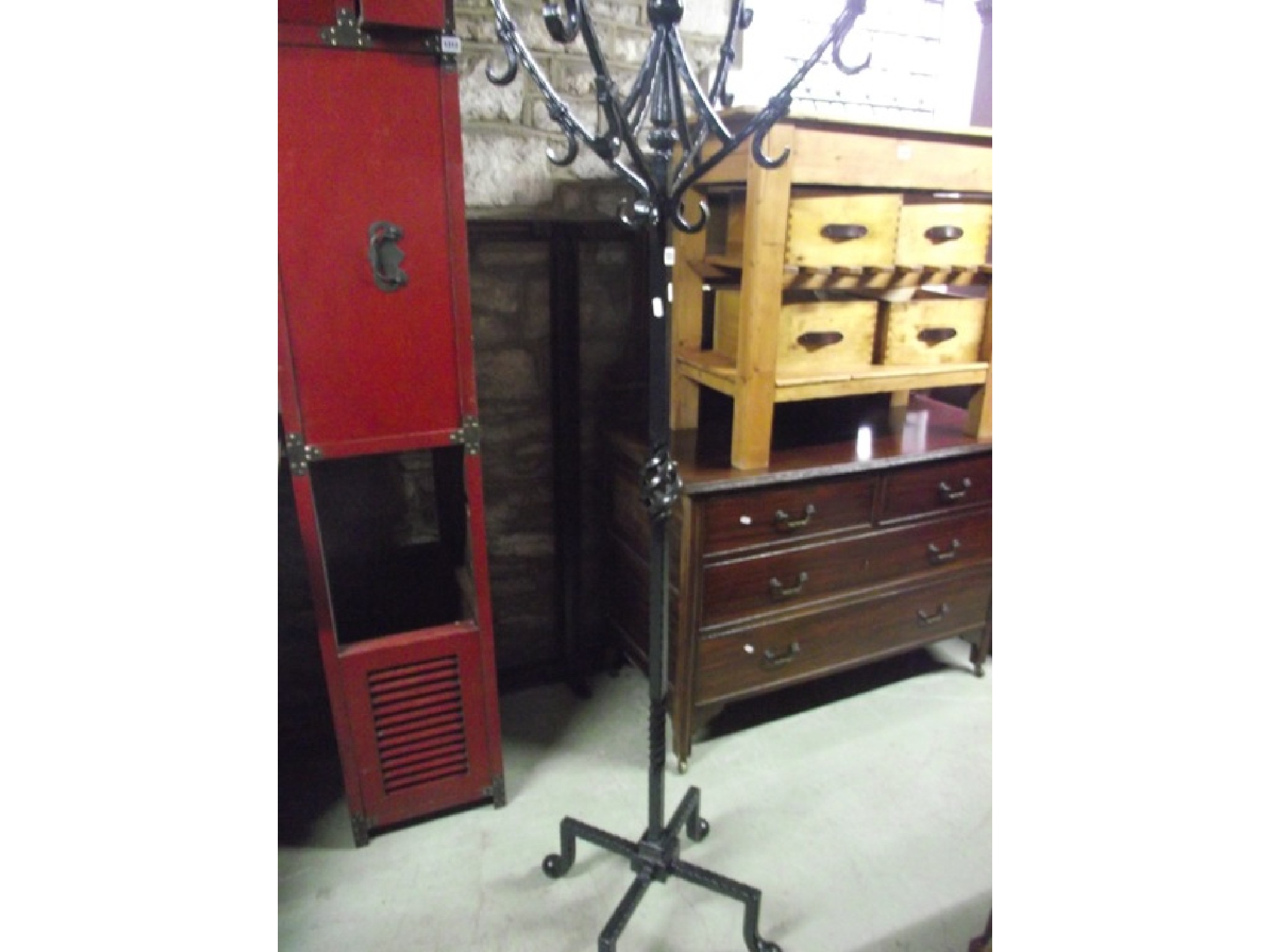 Appraisal: A heavy ironwork floorstanding hat coat stand the central square