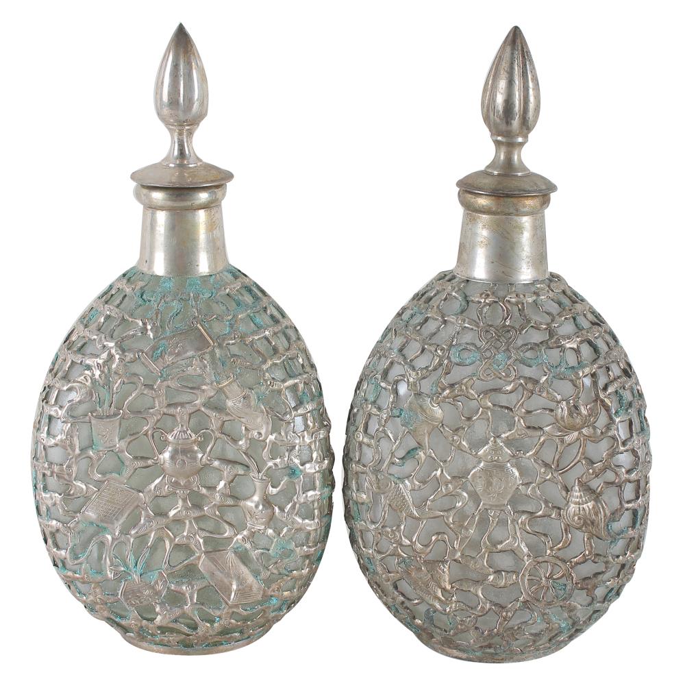 Appraisal: PAIR OF CHINESE OVERLAID DIMPLE BOTTLE DECANTERSglass with metal overlay