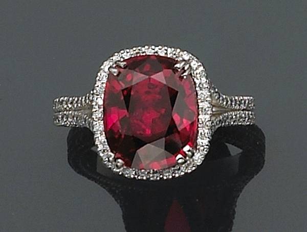 Appraisal: A ruby diamond and platinum ring centering a cushion-cut ruby