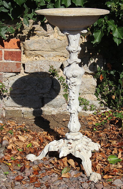 Appraisal: A CAST IRON BIRD BATH with three scrolling feet cm