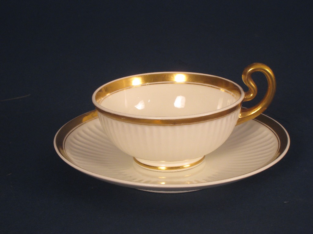 Appraisal: A Swansea Cup and Saucer semi fluted with gilt rims