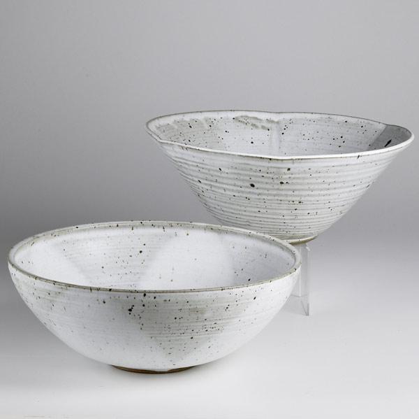 Appraisal: STEPHEN MERRITT Two large stoneware bowls each in a creamy