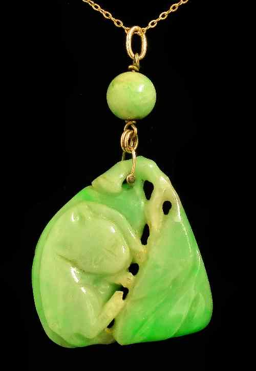 Appraisal: A Chinese pale green celadon jade triangular pattern pendant carved