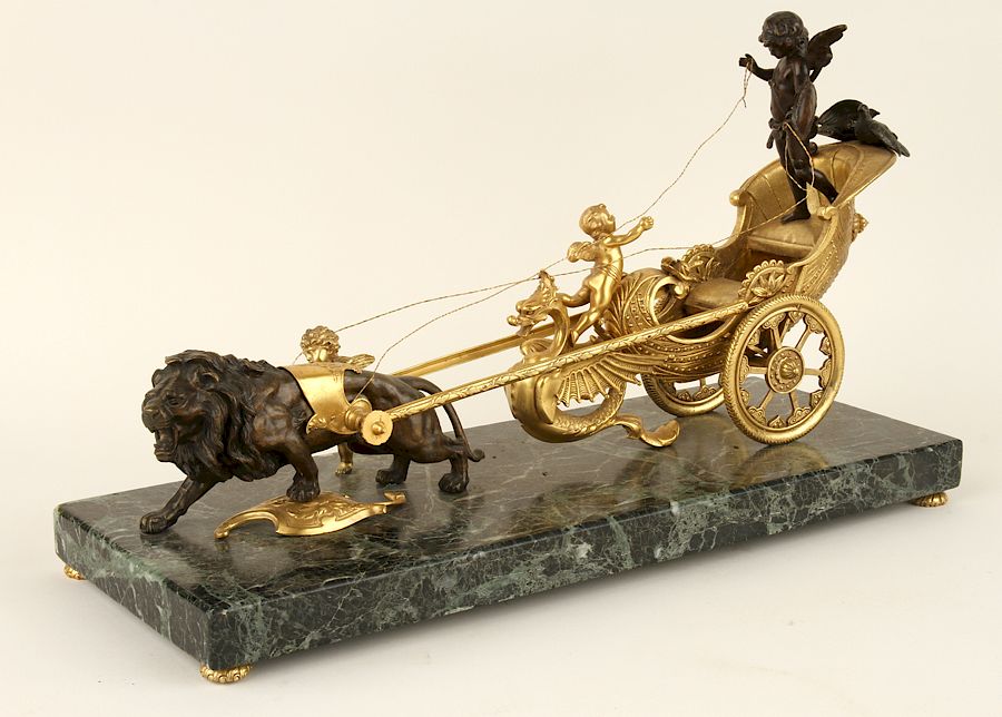 Appraisal: BRONZE FIGURAL GROUP OF PUTTO RIDING CHARIOT LION A bronze