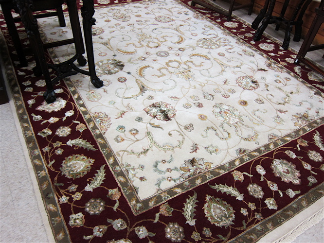 Appraisal: HAND KNOTTED ORIENTAL CARPET Indo-Persian having a rectangular cream field