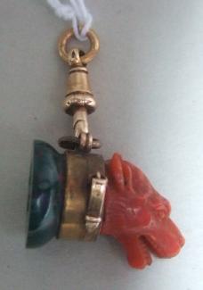 Appraisal: A Victorian bloodstone seal crest engraved the carved coral top