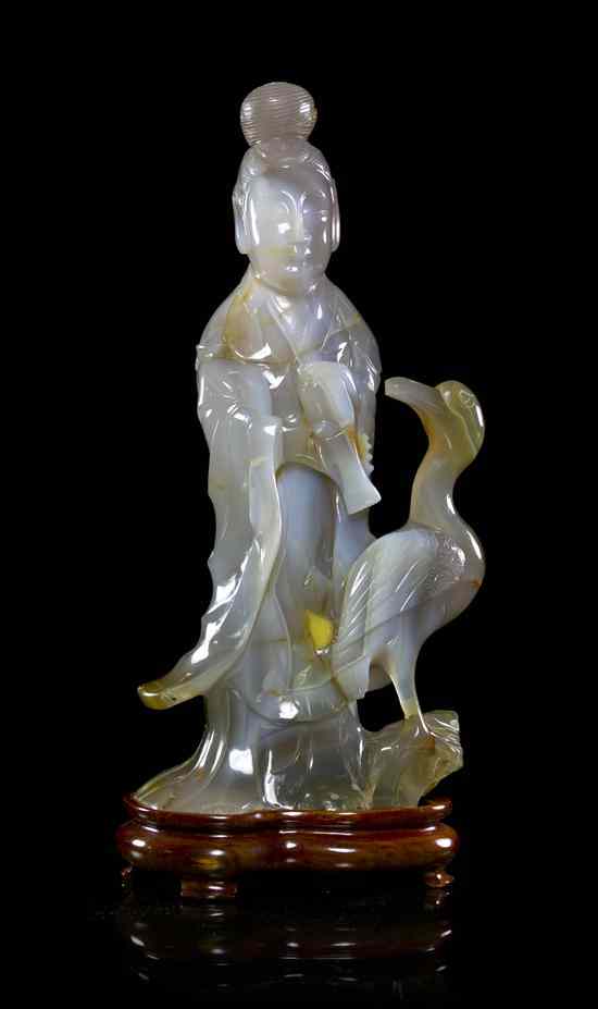 Appraisal: A Large Agate Carving of Guanyin the figure shown overturning