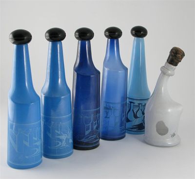 Appraisal: A set of six amorphic glass bottles printed with Surrealist